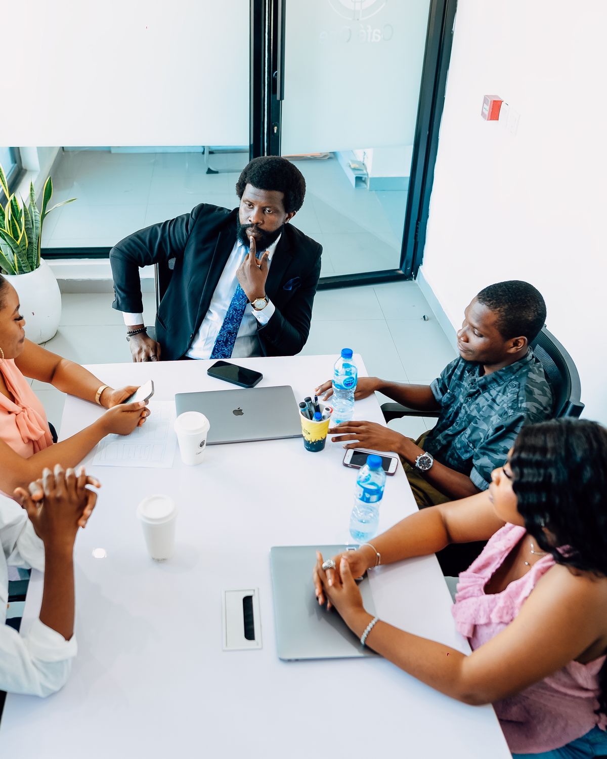 Professional team reviewing material together in a boardroom meeting